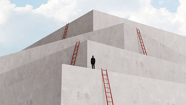 istock Man standing on minimalist tiered architectural platforms with red ladders, representing career growth, professional challenges, and the climb to success, 3D render 2252994012