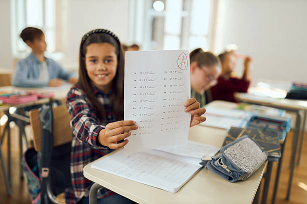 istock Happy student holding test with A grade 2252994087