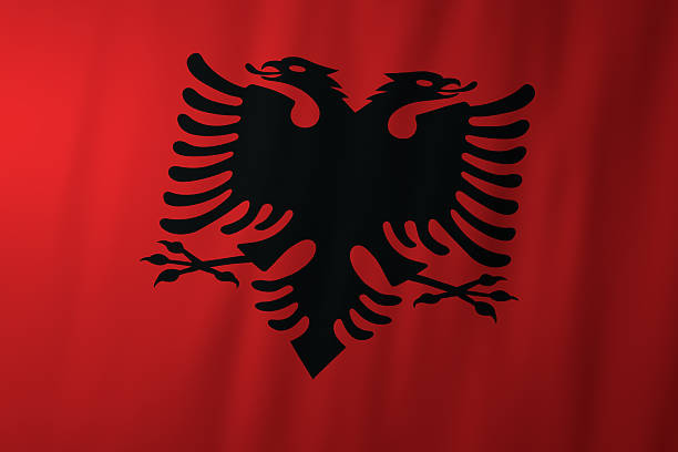 The national flag of Albania featuring a black double headed eagle centered on a red background. This powerful symbol represents strength, independence, and Albanian national identity.