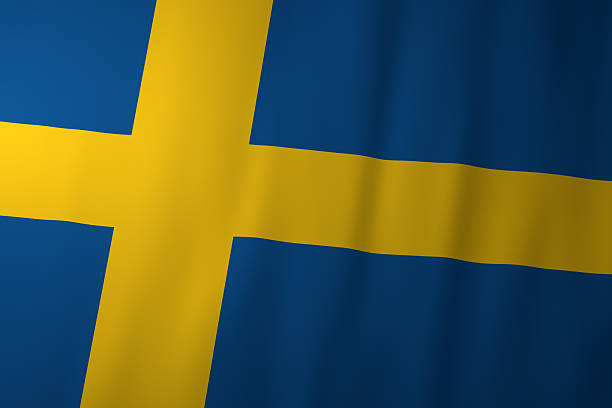 Small paper flag of Sweden pinned. Isolated on white background. Horizontal orientation. Close up photography. Copy space.