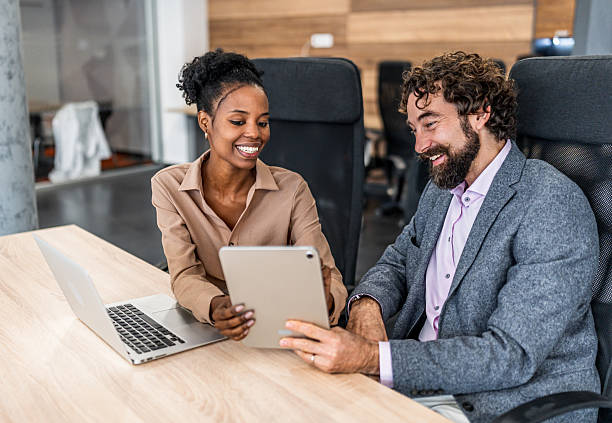 istock Diverse business colleagues collaborating on tablet in office 2252996635