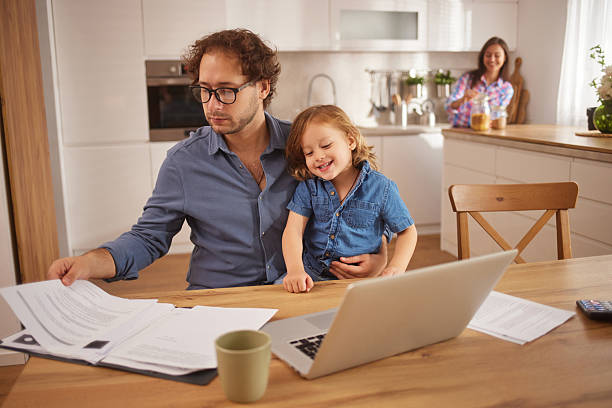 istock Father working from home with son while wife is in background 2252997507