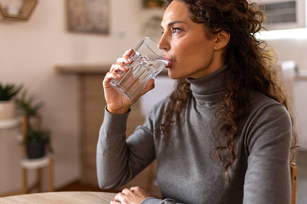 istock Woman Drinking Water at Home 2252998889