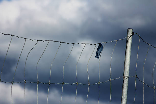 A bit of textile stuck in a big fence