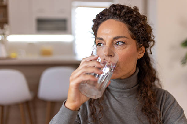 istock Woman Drinking Water at Home 2252998937