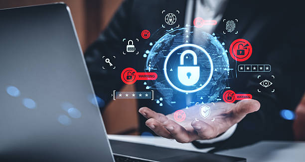 istock Cybersecurity data protection concept with glowing padlock icons over businessman's hands and laptop on a dark creative background in office setting. 2253001231