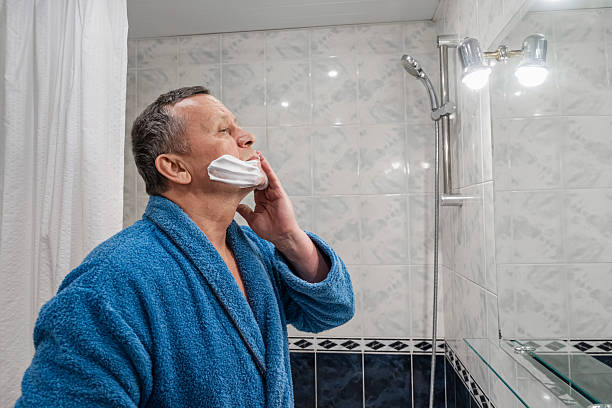 istock Man applying shaving foam in bathroom mirror 2253011602