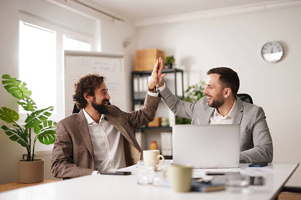 istock Business team collaborates in office setting, sharing ideas and building success during brainstorming session in modern workspace 2253011801