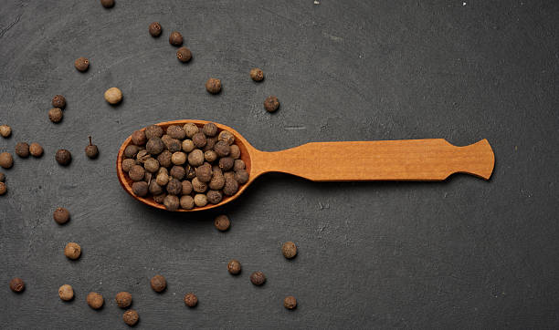 istock Allspice berries in a wooden spoon 2253014046