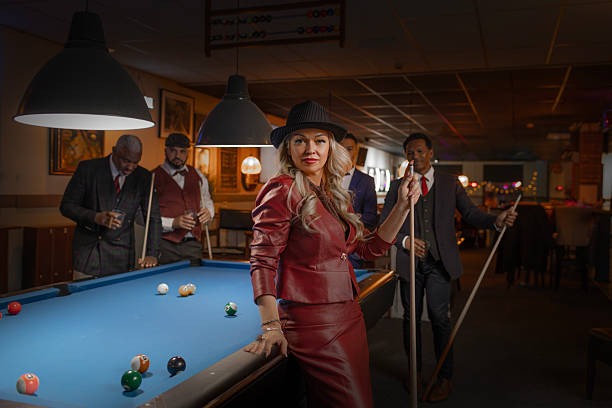 Small group of luxury diverse senior friends enjoying downtime at a pool hall in the Netherlands