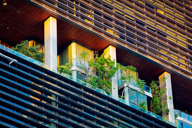 Trees in facade of modern office building in Bangkok downtown