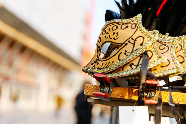 Intricate venetian carnival mask display with red and gold detailing