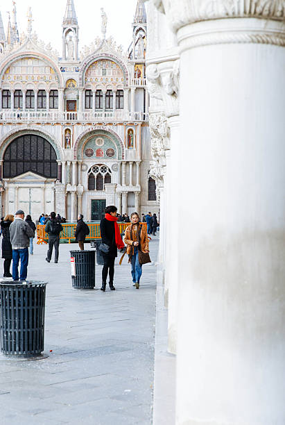 Venice, Italy - February 19, 2025: Tourists enjoying the beauty of St. Mark's Basilica in Venice, Italy, surrounded by historic architecture and lively ambiance