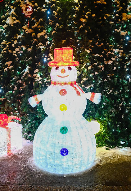 istock Illuminated snowman figure near Christmas tree 2253027555