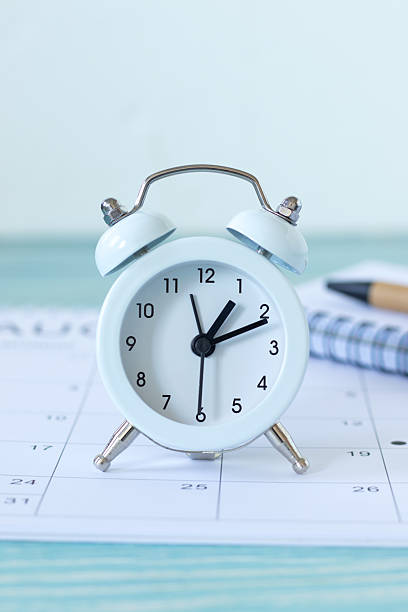 istock Alarm clock and calendar with white background 2253030678