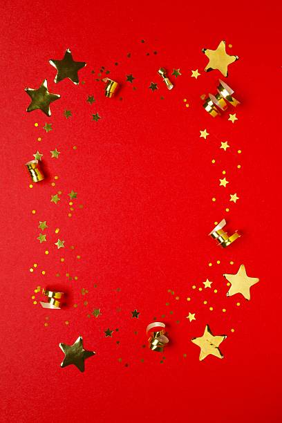 istock Golden confetti on red background, top view 2253031868
