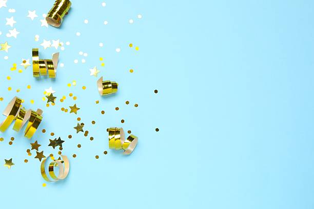 istock Golden confetti on blue background, top view 2253031888