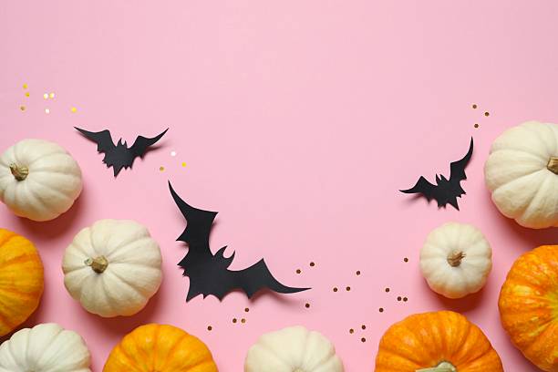 istock Different Halloween decorations including pumpkins and bats with confetti on color background 2253031918