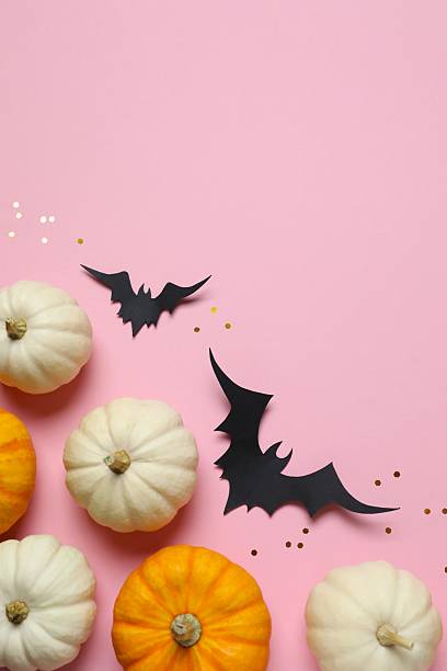 istock Different Halloween decorations including pumpkins and bats with confetti on color background 2253031933