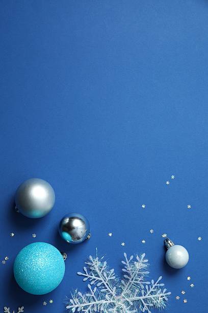 istock Top view of Christmas decorations and confetti on blue background 2253032069
