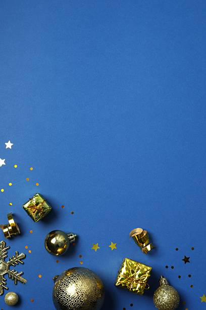 istock Top view of Christmas decorations and confetti on blue background 2253032099