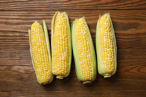 istock Fresh corn on cobs on wooden background, top view 2253032114