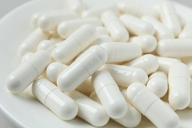 istock White medical capsules, close-up 2253032933