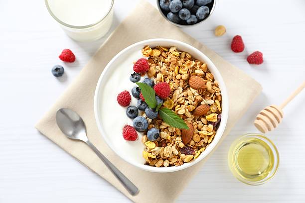 istock Delicious granola with berries and yogurt on a light background 2253033541