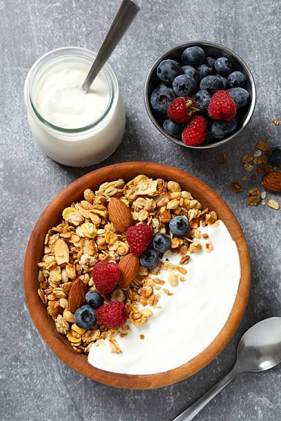 istock Delicious granola with berries and yogurt on a light background 2253033563