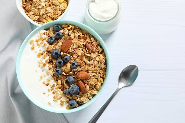 istock Delicious granola with berries and yogurt on a light background 2253033625