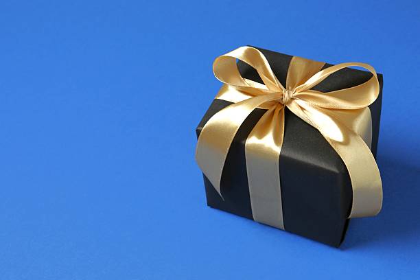 istock Beautiful festive gift box on blue background 2253034150