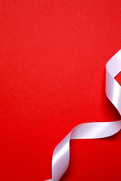istock Beautiful white silk ribbon on red background, space for text 2253034430