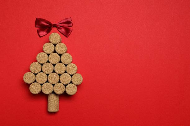 istock Christmas tree shaped wine corks on color background. Top view with copy space for text 2253034511