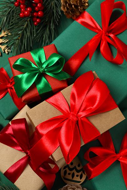 istock Beautiful gift boxes tied with bows and Christmas decorations on green background 2253035049