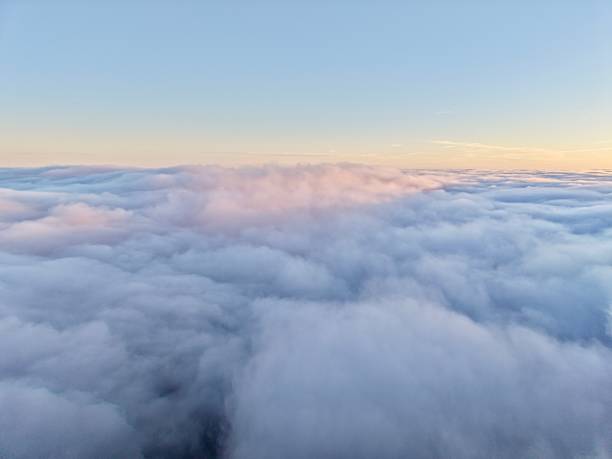 istock Calm Pastel Clouds Drift Over Sunrise Scene, Serene Morning Clouds Dance Beneath Glowing Sunrise Horizon 2253036124