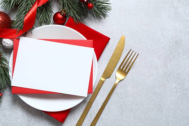 istock New Year table setting with paper card on gray background 2253036604