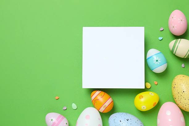 istock Happy Easter. Colorful eggs with paper card on color background, space for text or advertising 2253037391