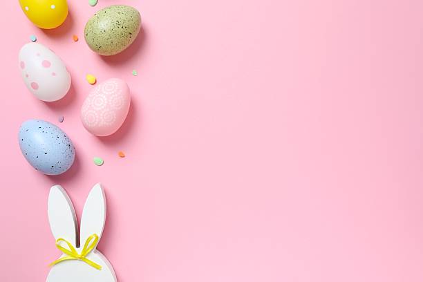 istock Happy Easter. Colorful eggs with bunny ears on color background, space for text or advertising 2253037412