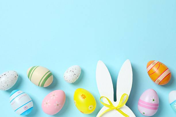 istock Happy Easter. Colorful eggs with bunny ears on color background, space for text or advertising 2253037453
