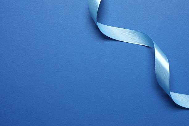 istock Beautiful blue silk ribbon on a color background 2253037876