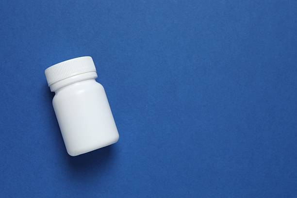 istock Medicine bottle on blue background 2253038154