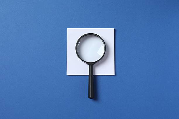 istock Magnifying glass with paper sticker on blue background 2253038284