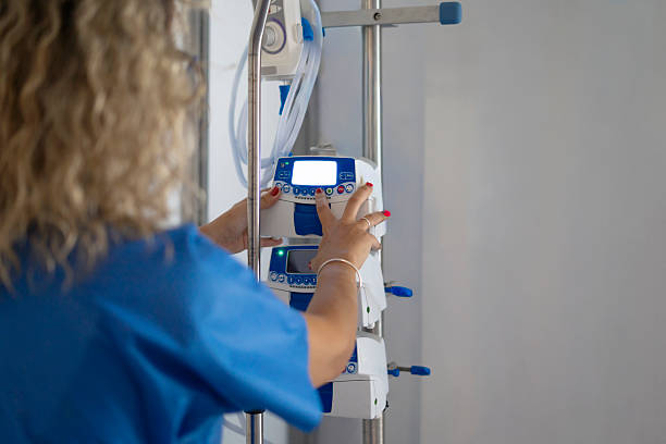 istock Nurse adjusting medical infusion pump in hospital setting 2253043864