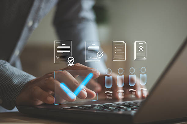 istock Businessman approving digital documents on laptop with virtual checkmark, verified file interface, document verification, workflow approval, compliance process, HR management and business efficiency. 2253048453