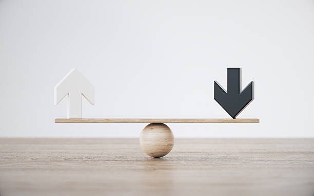 istock White and Black Arrow On Wooden Background - Seesaw Balance Scale Concept 2253049607