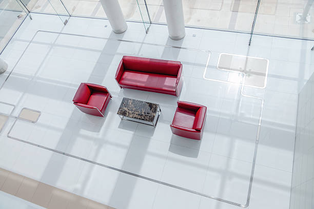 istock Modern empty seating area with red sofas in contemporary shopping mall interior viewed from above 2253058271