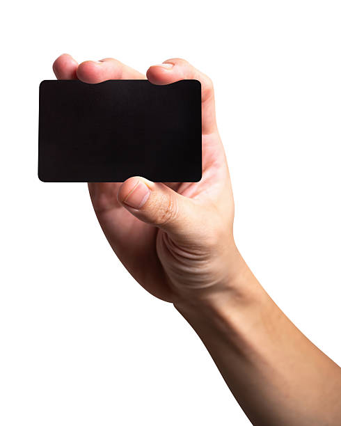 istock Man hand hold black credit card isolated on white background. 2253059435