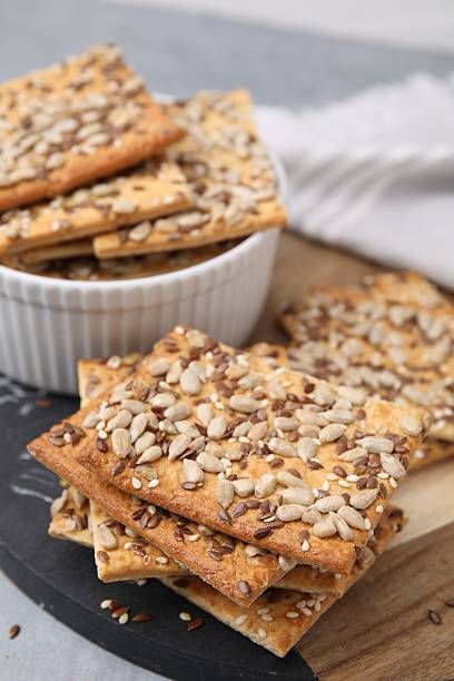 istock Cereal crackers with flax, sunflower and sesame seeds on table, closeup 2253060868