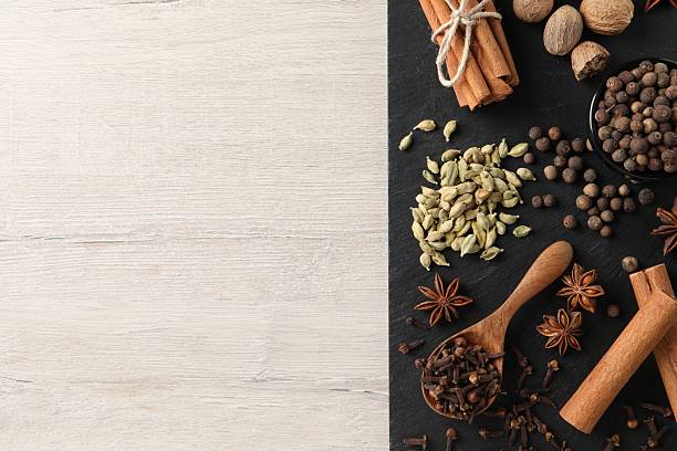 istock Different spices on wooden table, top view. Space for text 2253062399