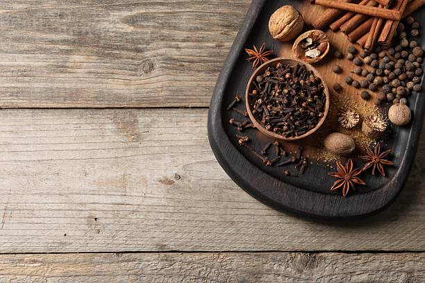 istock Different spices and nuts on wooden table, top view. Space for text 2253062973